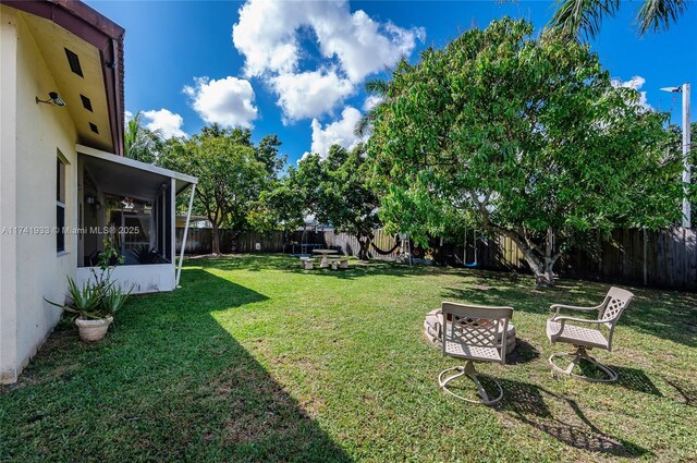 view of yard with an outdoor fire pit