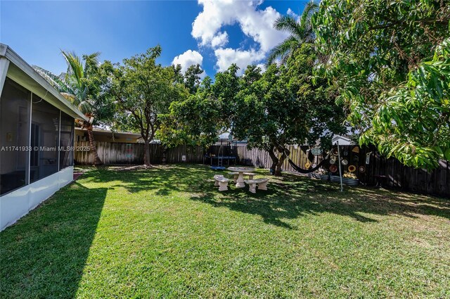 view of yard featuring a sunroom