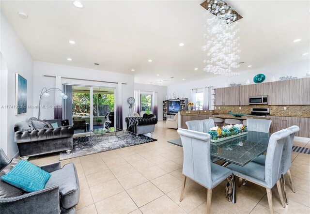 tiled dining space featuring sink and a wealth of natural light