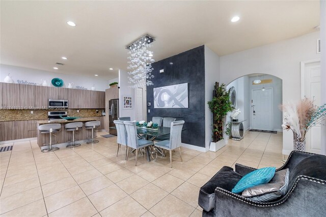 dining space featuring light tile patterned floors