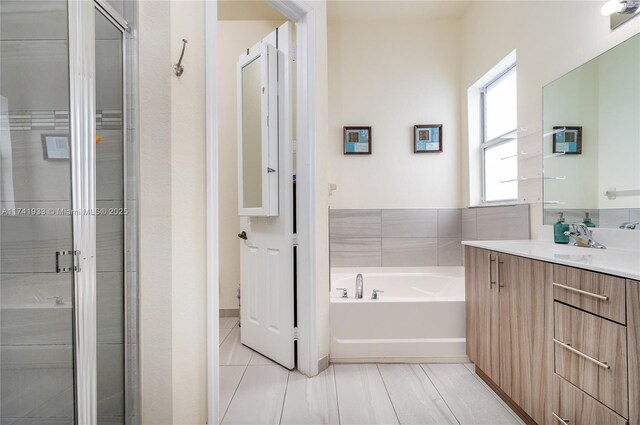 bathroom featuring vanity, shower with separate bathtub, and tile patterned flooring