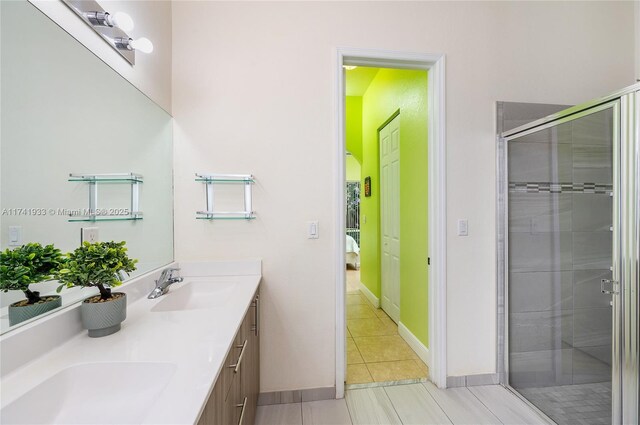 bathroom featuring vanity, tile patterned floors, and a shower with shower door