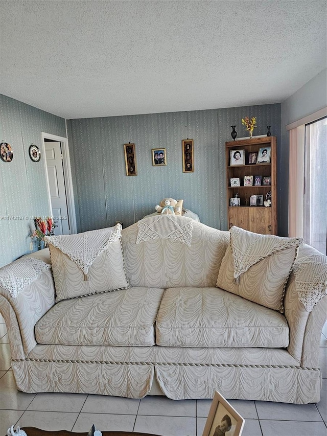 living room with tile patterned flooring and a textured ceiling