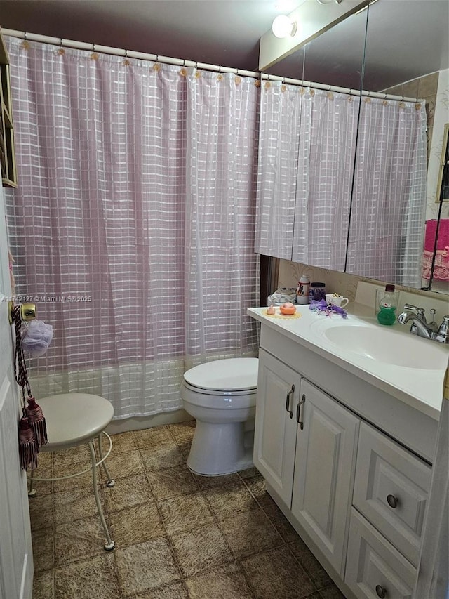 bathroom featuring vanity and toilet