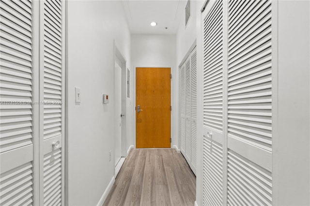 hallway with light wood-type flooring