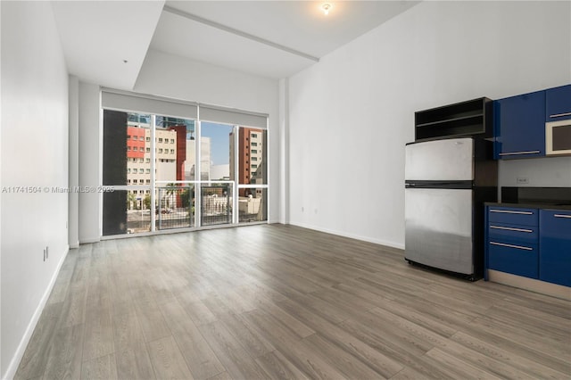 unfurnished living room with wood-type flooring