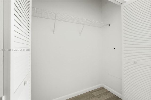 walk in closet featuring hardwood / wood-style flooring