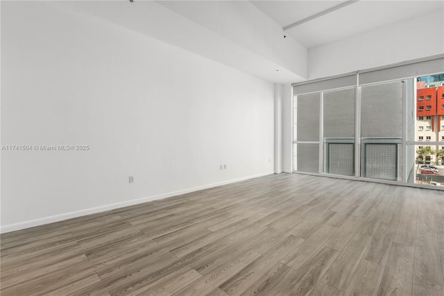 empty room with hardwood / wood-style floors