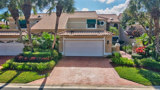 mediterranean / spanish house with a garage