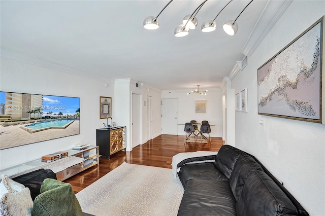 living room featuring crown molding, dark hardwood / wood-style floors, and a chandelier