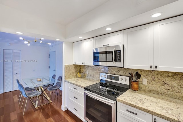 kitchen featuring backsplash, appliances with stainless steel finishes, dark hardwood / wood-style floors, and white cabinets