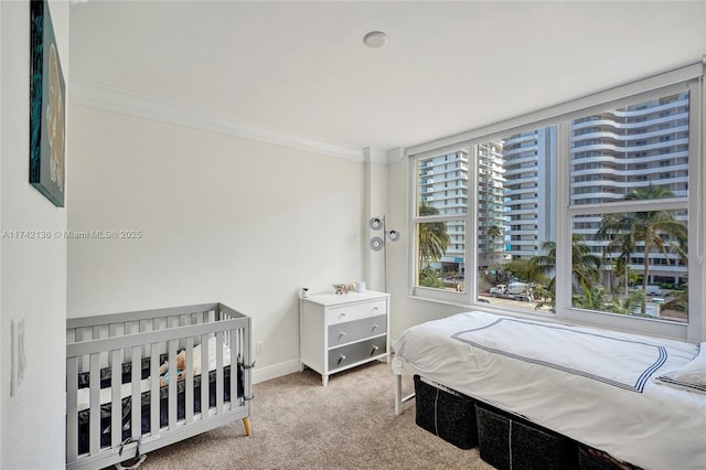 bedroom featuring ornamental molding and carpet floors