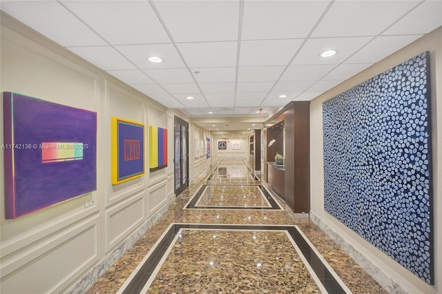 hallway featuring a paneled ceiling