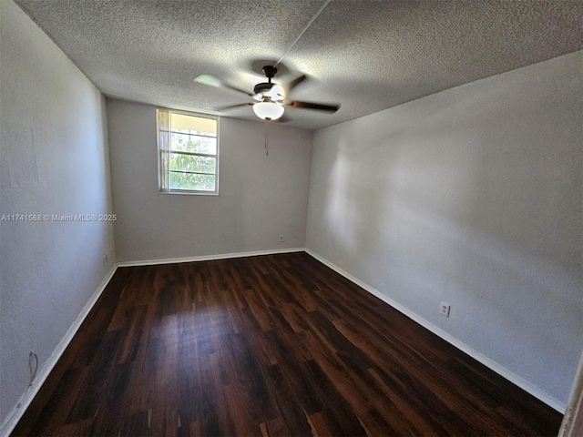 spare room with ceiling fan, dark wood-type flooring, and a textured ceiling