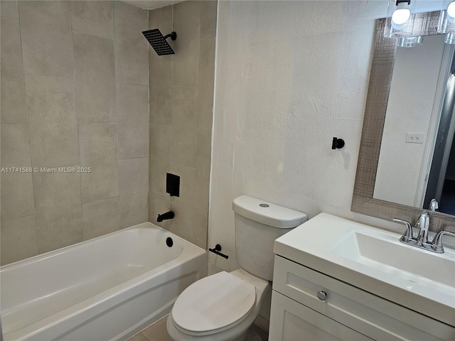 full bathroom with tiled shower / bath, vanity, and toilet