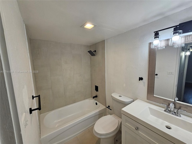 full bathroom with tiled shower / bath, vanity, toilet, and tile patterned floors