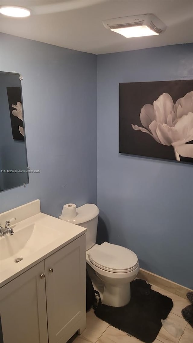 bathroom featuring vanity and toilet