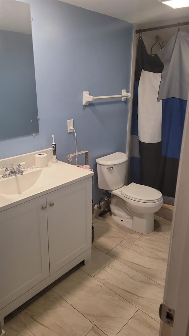 bathroom with vanity and toilet