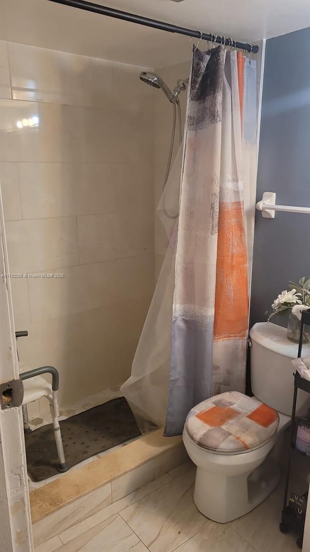 bathroom with toilet and walk in shower