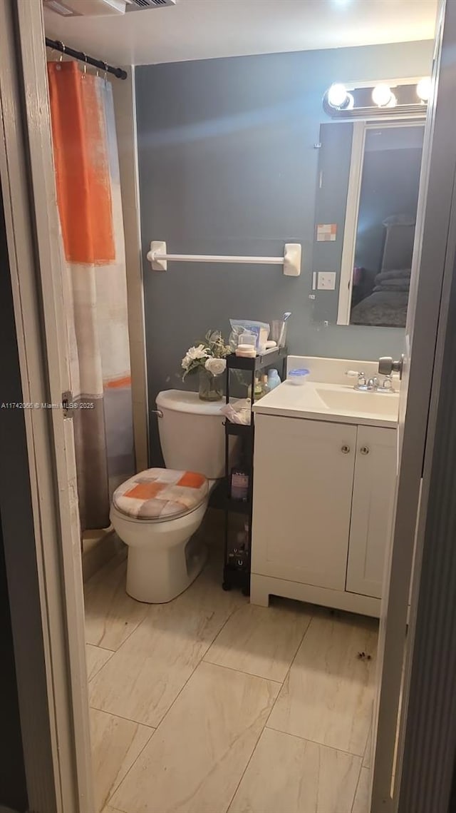 bathroom featuring vanity and toilet