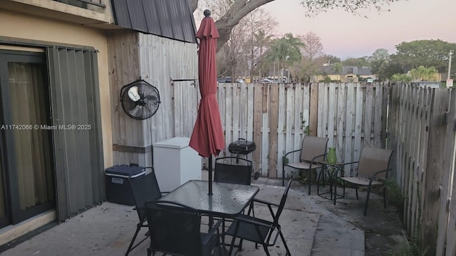 view of patio terrace at dusk