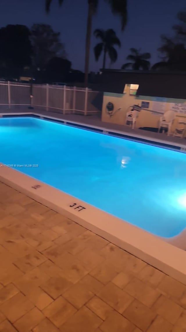 view of pool at night