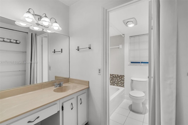 bathroom with vanity, toilet, tile patterned flooring, and a washtub