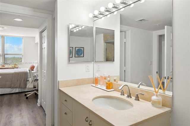 bathroom with vanity and hardwood / wood-style flooring