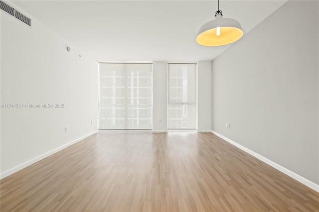 unfurnished room with light hardwood / wood-style floors