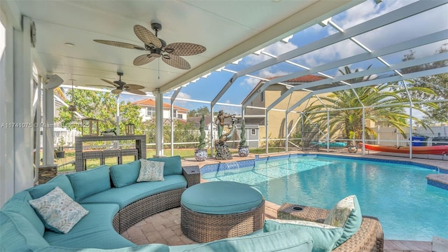 view of pool with ceiling fan, an outdoor hangout area, and glass enclosure