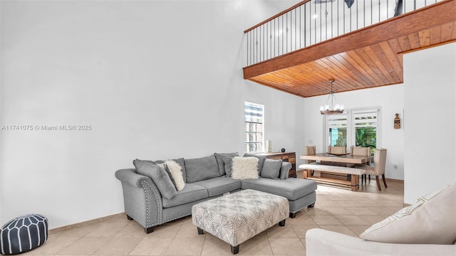 living room featuring a high ceiling, light tile patterned floors, wood ceiling, and an inviting chandelier