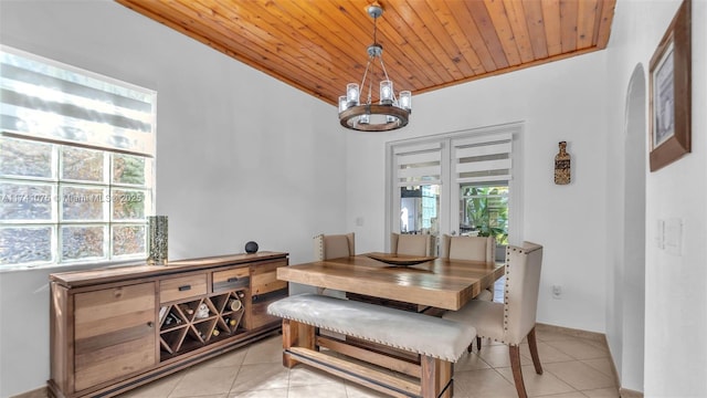 dining area featuring a notable chandelier, wooden ceiling, lofted ceiling, and light tile patterned floors