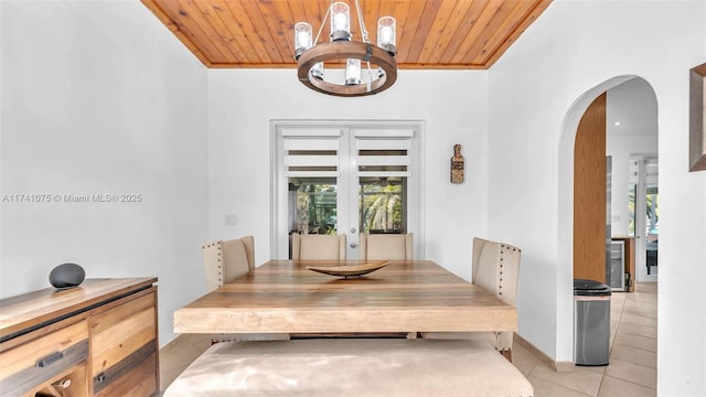 dining space featuring beverage cooler, wooden ceiling, french doors, and light tile patterned flooring