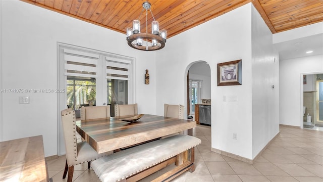 tiled dining area with an inviting chandelier and wood ceiling