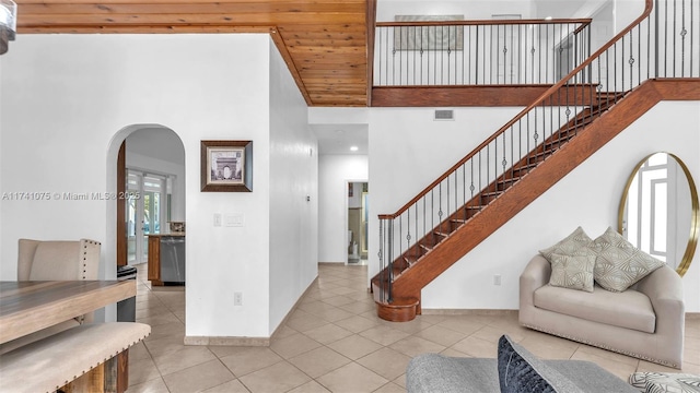 tiled entrance foyer with a towering ceiling