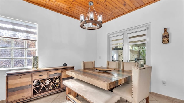 tiled dining area featuring an inviting chandelier and wood ceiling