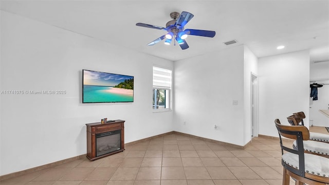 living room with ceiling fan and light tile patterned floors