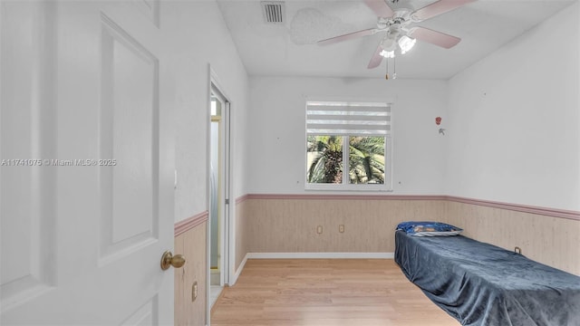 bedroom with wood-type flooring and ceiling fan