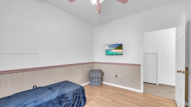 bedroom with wood-type flooring and ceiling fan