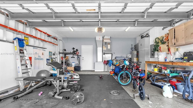 garage with a garage door opener and gas water heater