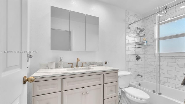 full bathroom featuring vanity, enclosed tub / shower combo, and toilet