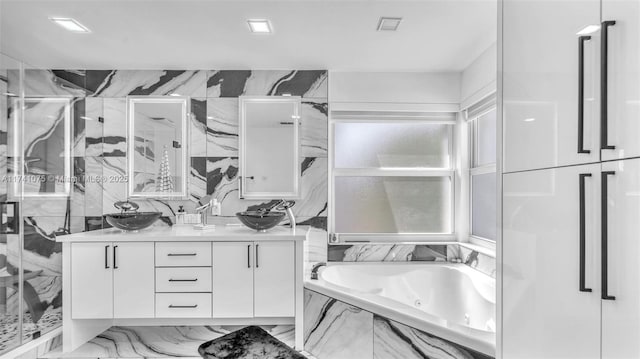 bathroom featuring vanity, tile walls, and separate shower and tub