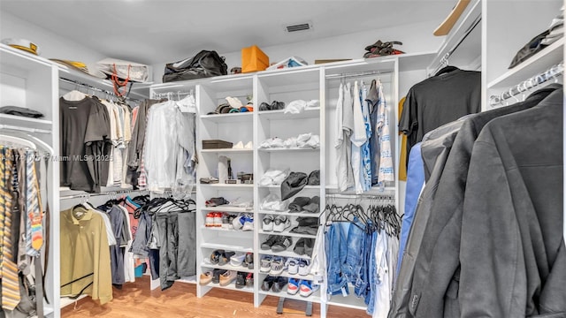 spacious closet featuring light hardwood / wood-style floors