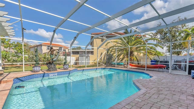 view of pool with a lanai and a patio