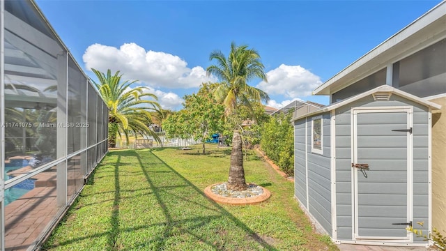 view of yard with a storage shed and a lanai