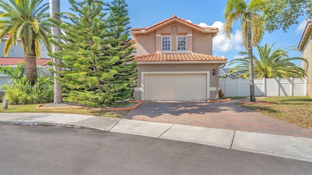 mediterranean / spanish-style home with a garage