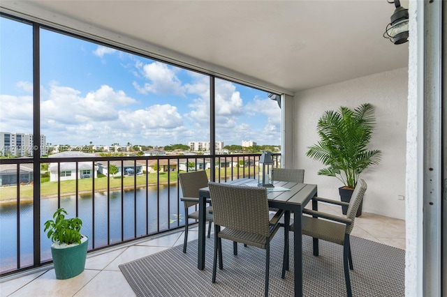 sunroom / solarium with a water view