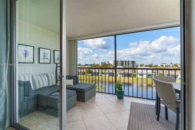 sunroom featuring a water view and a healthy amount of sunlight