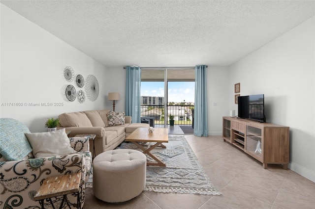 living room featuring a textured ceiling and light tile patterned floors