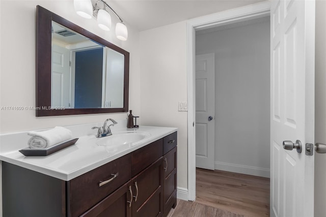 bathroom with vanity and hardwood / wood-style floors